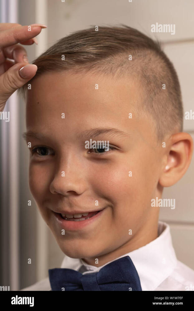 ront-of-the-mirror-mom-straightens-her-hair-W1W7EF.jpg