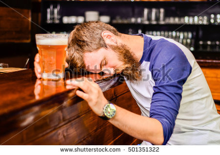 stock-photo-bearded-drunk-man-sleeps-with-barney-table-with-a-glass-of-beer-501351322.jpg