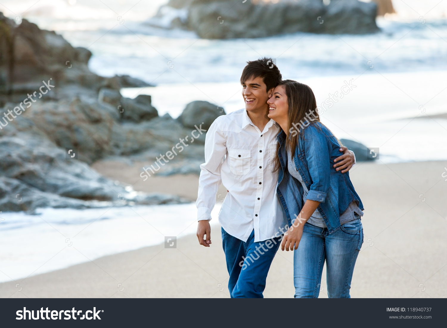 stock-photo-cute-happy-teen-couple-wandering-along-the-beach-118940737.jpg