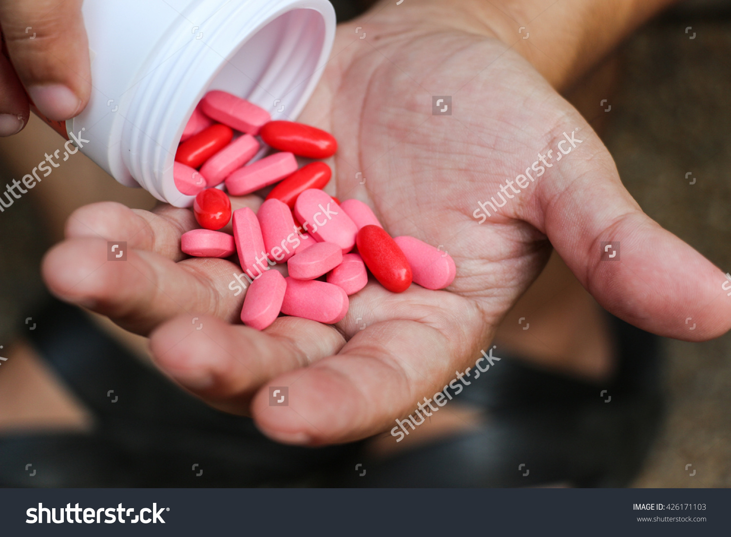stock-photo-overdose-drug-addict-hand-pink-and-red-pills-on-hand-426171103.jpg